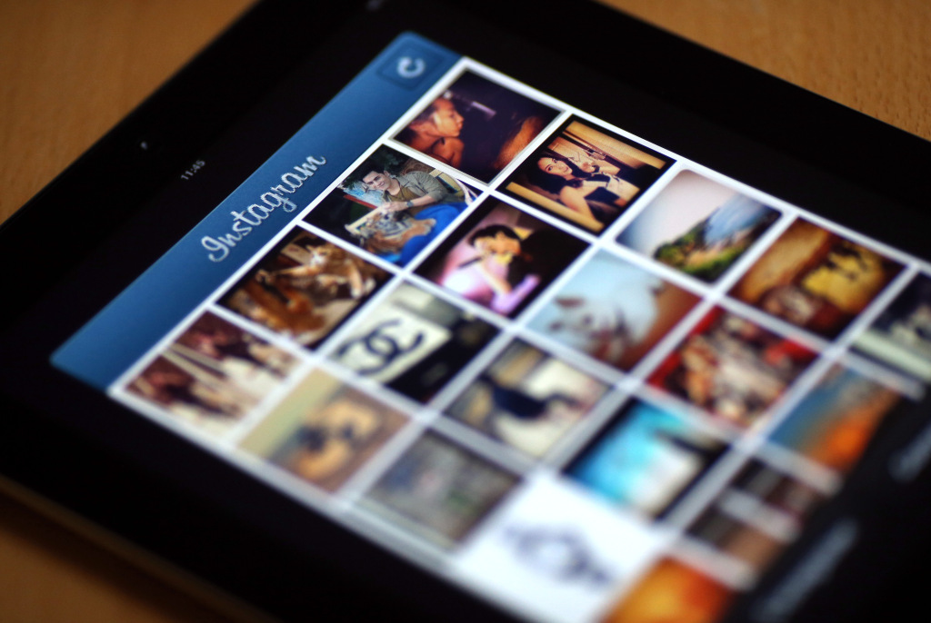 Pictures appear on the smartphone photo sharing application Instagram on April 10, 2012 in Paris, one day after Facebook announced a billion-dollar-deal to buy the startup behind Instagram. The free mini-program lets people give classic looks to square photos using "filters" and then share them at Twitter, Facebook or other social networks. AFP PHOTO THOMAS COEX (Photo credit should read THOMAS COEX/AFP/GettyImages)